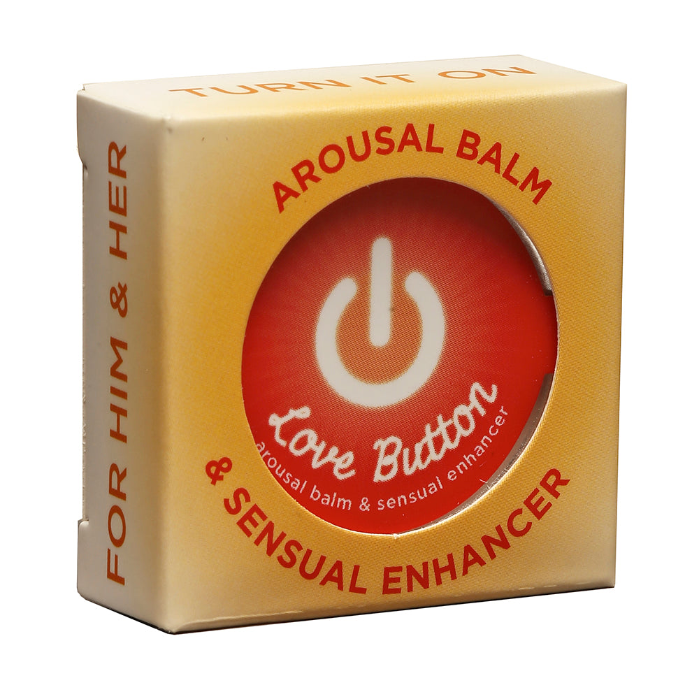Earthly Body Love Button Tin .3oz arousal balm tin on a nightstand with subtle warm lighting.
