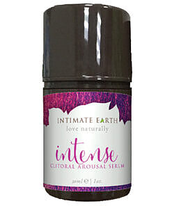 Intimate Earth Intense Clitoral Arousal Serum 1 oz bottle with pump top on a bedside table