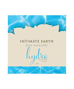 Intimate Earth Hydra Natural Glide 3 ml foil packet displayed next to a ruler for scale with clear gel texture visible.
