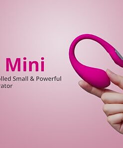next to its magnetic USB charger on a white surface.