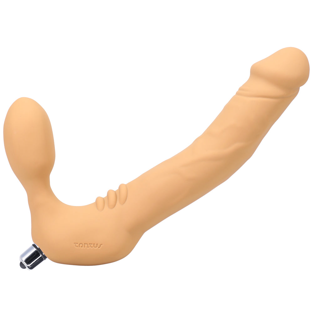 Honey-colored silicone strapless vibrating strap-on with curved shaft and internal bulb on a plain background.