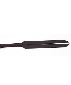 Tantus Tawse Small Paddle Whip with dual 1.5-inch black silicone tongues and ergonomic handle on a dark mat.
