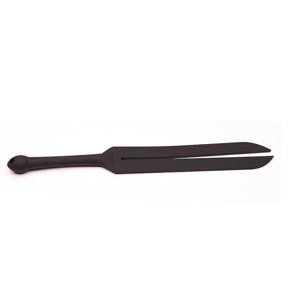 Tantus Tawse Small Paddle Whip with dual 1.5-inch black silicone tongues and ergonomic handle on a dark mat.