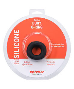 Tantus Buoy C-Ring Medium Onyx lying on a smooth