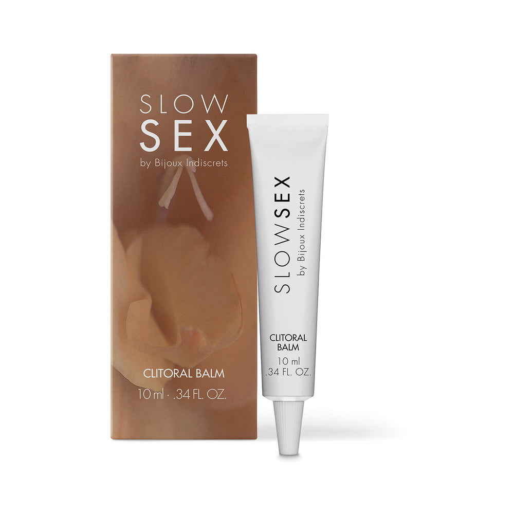 Bijoux Indiscrets Slow Sex Clitoral Balm jar with warming balm on fingertip