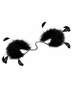Close-up of Bijoux Indiscrets Za Za Zu Feather Cuffs with black and white marabou fluff and metal buckle gleaming.