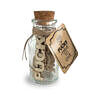 Jar Of Fucks I Have To Give clear glass jar with fifteen wooden tokens on desk surface next to coffee cup