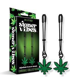 Silver tweezer nipple clamps with green cannabis leaf charms on a dark background.