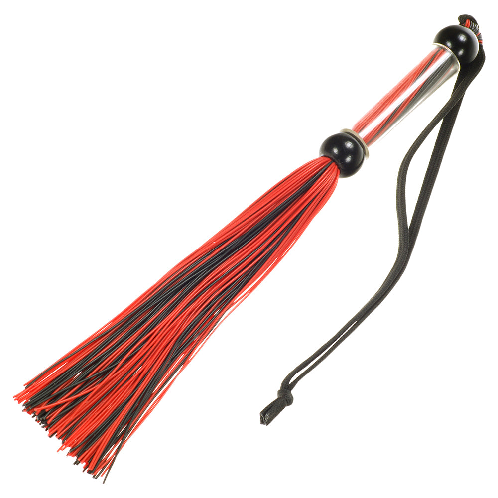 Black silicone flogger with slender tails and wrist strap displayed on a white surface.