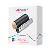 Lovense Solace Pro interactive male device on a nightstand with soft LED glow and visible charging cable.