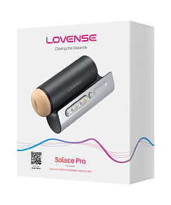 Lovense Solace Pro interactive male device on a nightstand with soft LED glow and visible charging cable.