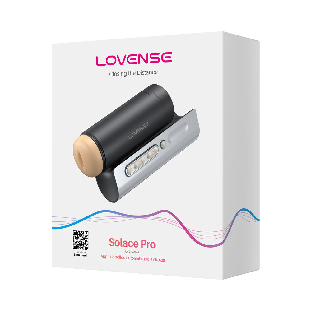 Lovense Solace Pro interactive male device on a nightstand with soft LED glow and visible charging cable.