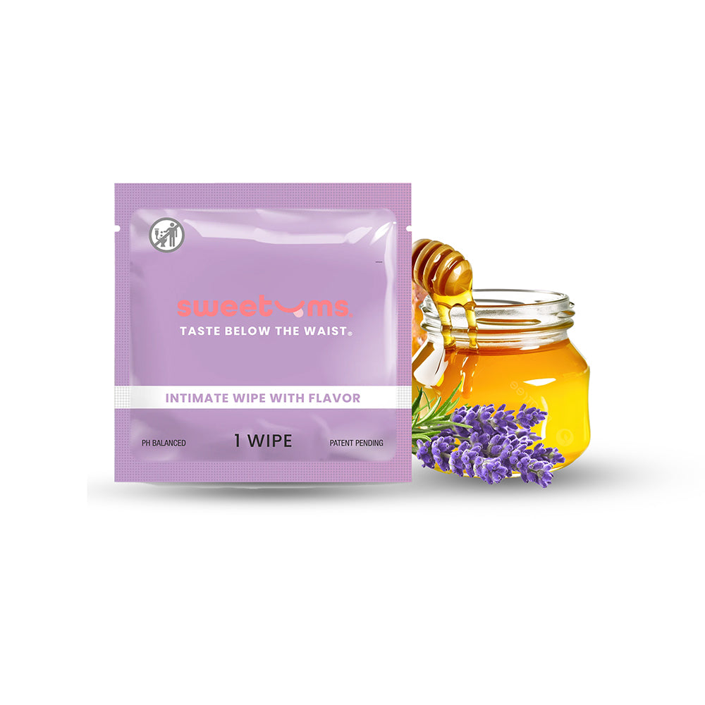 Open packet of Sweetums Honey Lavender Intimate Wipe with soft lavender floral artwork and foil wrapper on white background