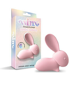 Pink silicone WINX Babbitty Rabbitty Bunny Vibrator with rabbit ears and USB cable on a white bathroom counter.