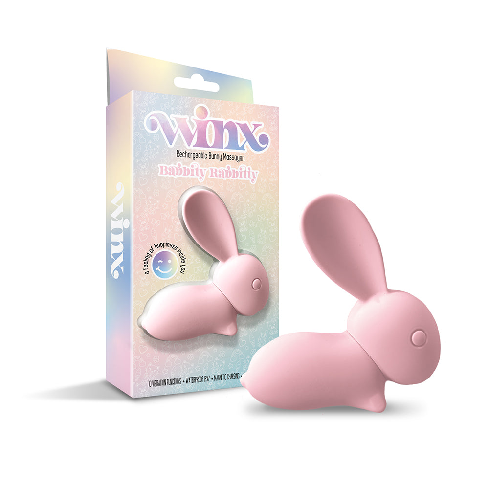Pink silicone WINX Babbitty Rabbitty Bunny Vibrator with rabbit ears and USB cable on a white bathroom counter.