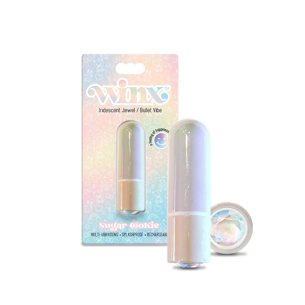 Iridescent WINX Sugar Cookie Bullet Vibrator with gemstone tip next to USB cable on a nightstand.