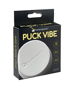Banana Pants Puck Vibe White/Black bullet vibe with remote control and magnetic USB charger on a dark background