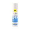 pjur TOY GLIDE 3.4 oz water-based lubricant bottle beside a colorful silicone toy on a soft surface