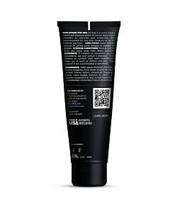 creamy white lotion droplet on a sleek dark surface.