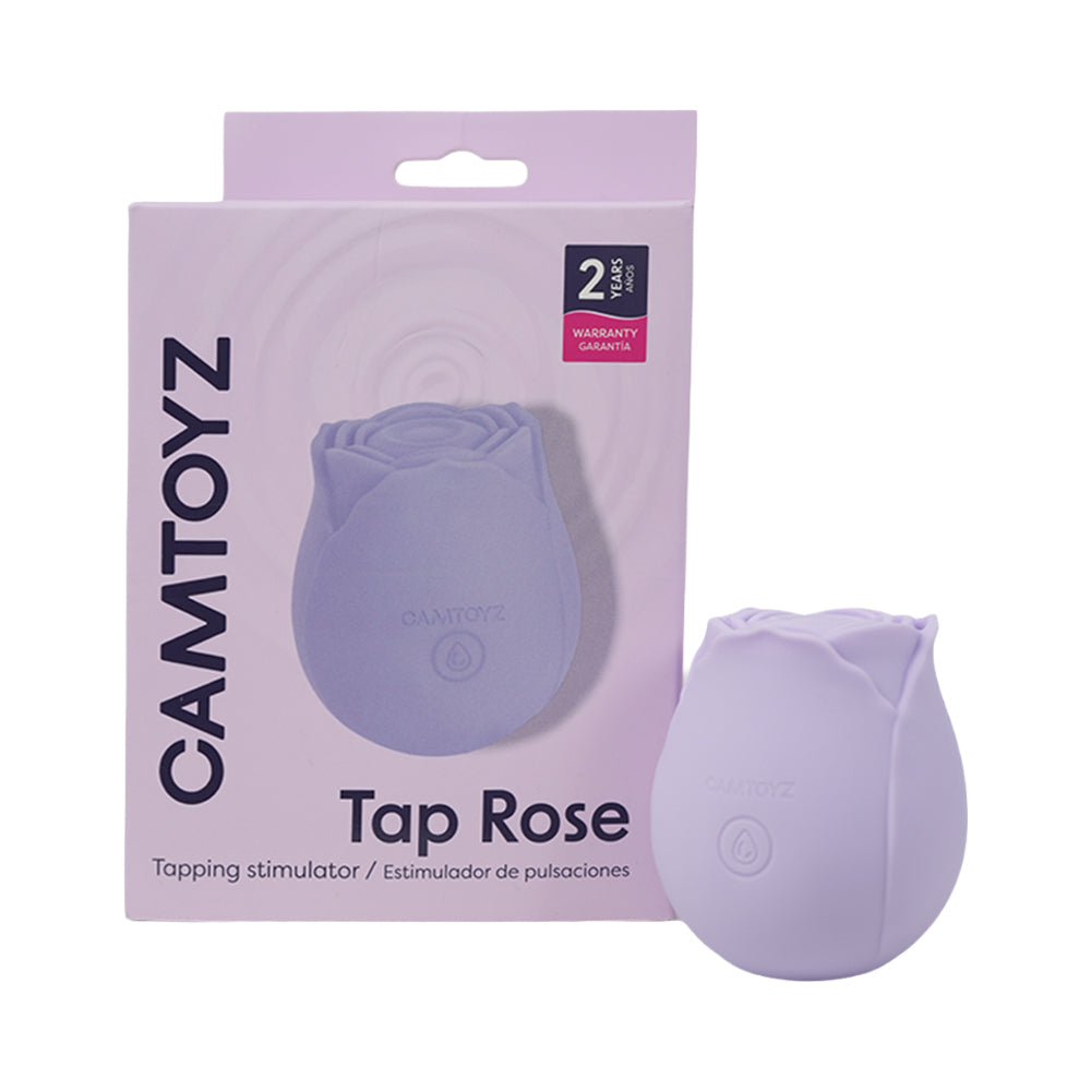Camtoyz Tap Rose Pulsation Stimulator in soft pink silicone held against a delicate rose petal background.