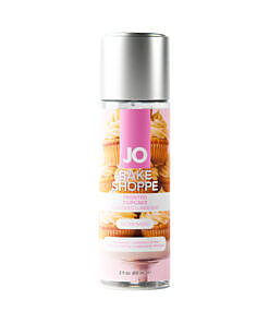 JO Bake Shoppe Frosted Cupcake Flavored Water-Based Lubricant 2 oz bottle with pink frosted cupcake and white icing on a pastel blue background.