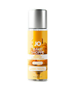 JO Bake Shoppe Orange Creampuff lubricant 2 oz bottle on white surface with dessert-themed label.