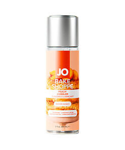 JO Bake Shoppe Peach Cobbler Flavored Water-Based Lubricant 2 oz bottle against a backdrop of fresh peaches.
