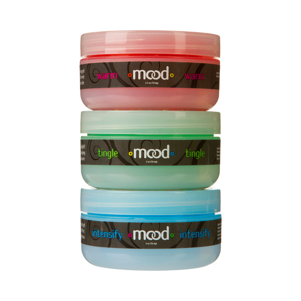 Mood Arousal Gels 3 Pack with Tingle Warm Intensify bottles on a nightstand