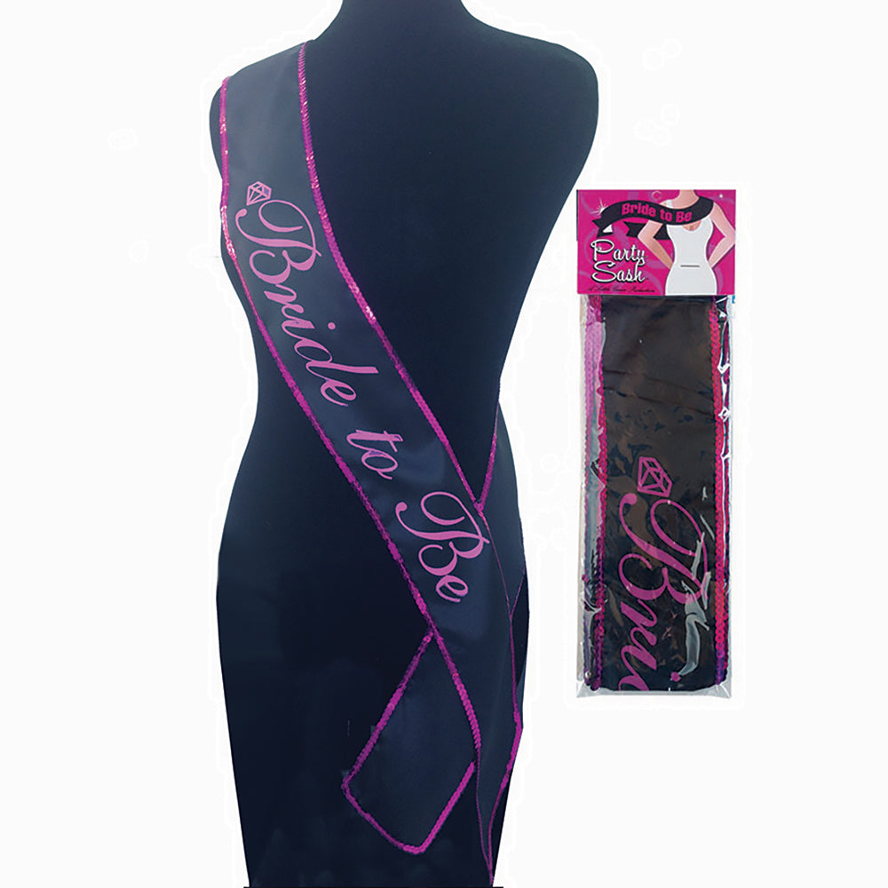 Bride To Be Sash sparkling silver glitter with safety pin draped on white chair at bridal shower.