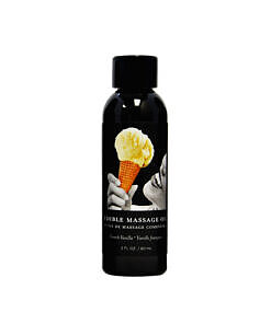 Earthly Body Edible Vanilla Massage Oil 2oz bottle with vanilla beans on a natural massage setup