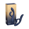 Midnight blue We-Vibe Nova 2 flexible silicone rabbit vibrator laying on satin sheet with charging cable beside it.