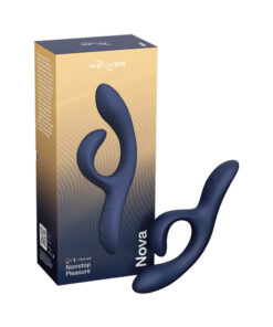 Midnight blue We-Vibe Nova 2 flexible silicone rabbit vibrator laying on satin sheet with charging cable beside it.