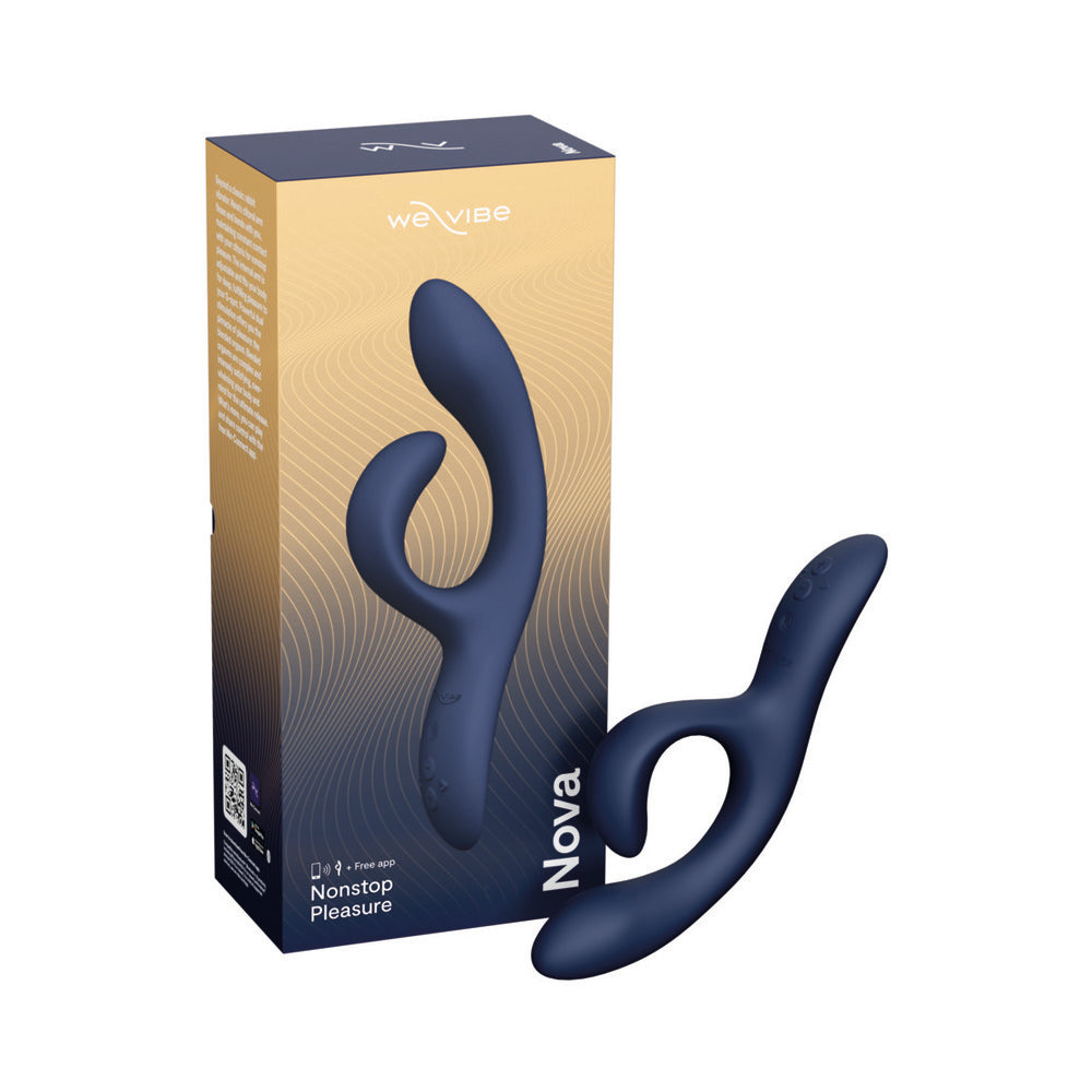 Midnight blue We-Vibe Nova 2 flexible silicone rabbit vibrator laying on satin sheet with charging cable beside it.