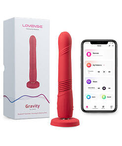 Lovense Gravity Thrusting Dildo with suction cup attached to a tiled shower wall