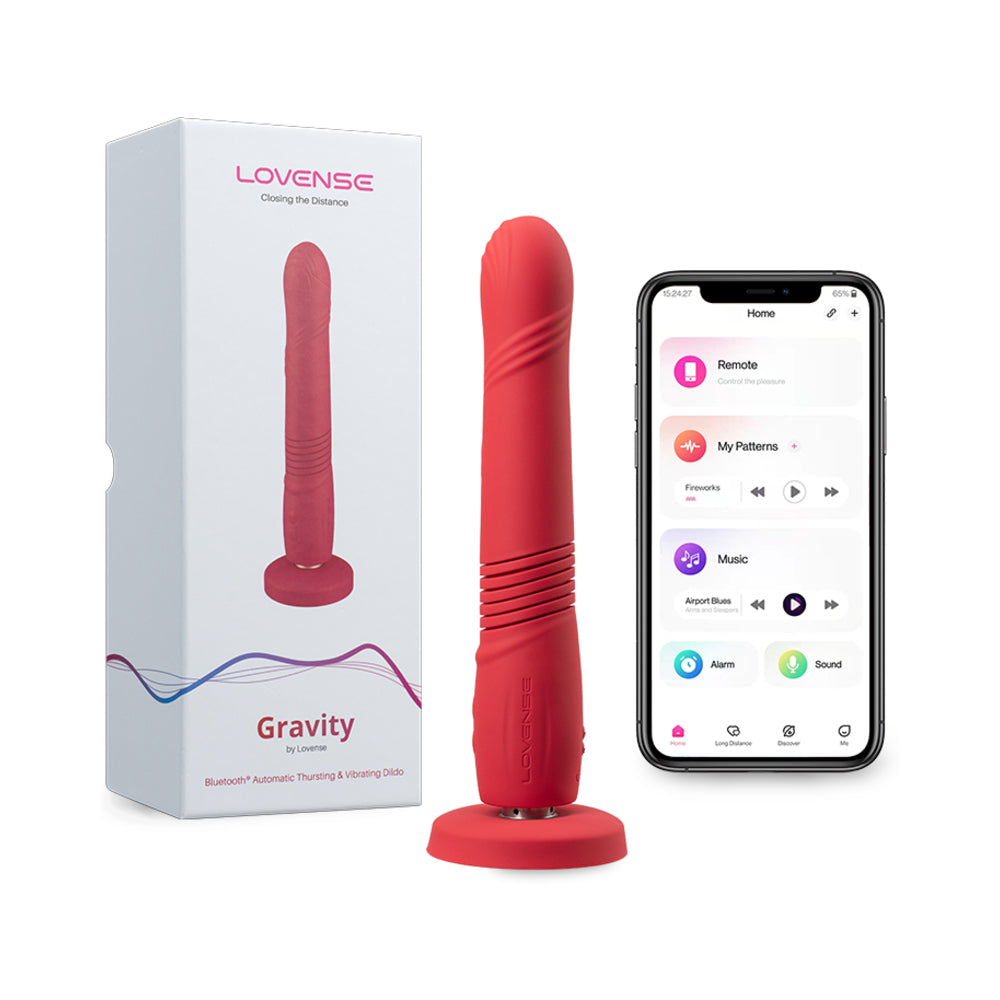 Lovense Gravity Thrusting Dildo with suction cup attached to a tiled shower wall