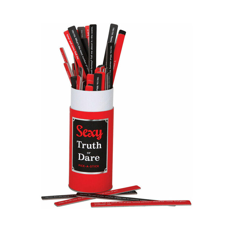 Sexy Truth or Dare Pick-A-Stick game box open on a bed with scattered double-sided sticks and soft candlelight.