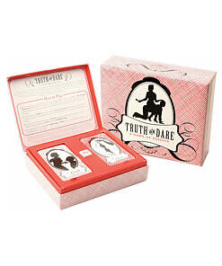 Truth or Dare: A Game of Passion card deck in a hinged box with dice on a romantic evening table setting.