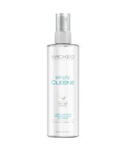 Wicked Simply Cleene Toy Cleaner 4 oz spray bottle standing upright on a light surface with lavender flowers and olive leaves beside it
