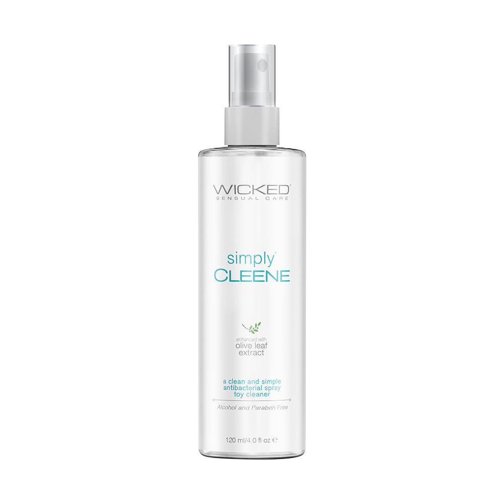 Wicked Simply Cleene Toy Cleaner 4 oz spray bottle standing upright on a light surface with lavender flowers and olive leaves beside it