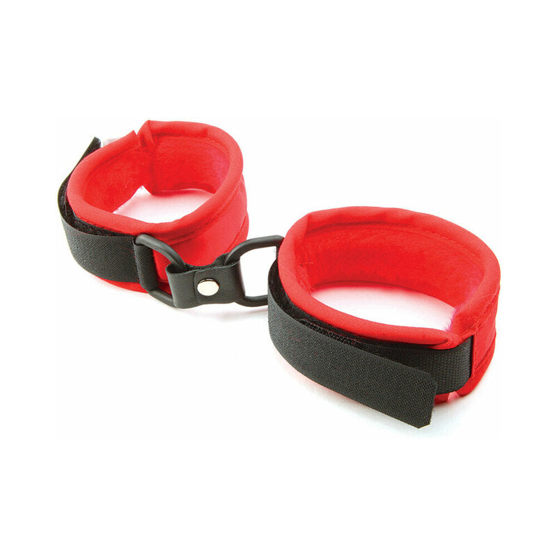 Red faux fur handcuffs with soft plush lining and polished metal connectors on a dark background