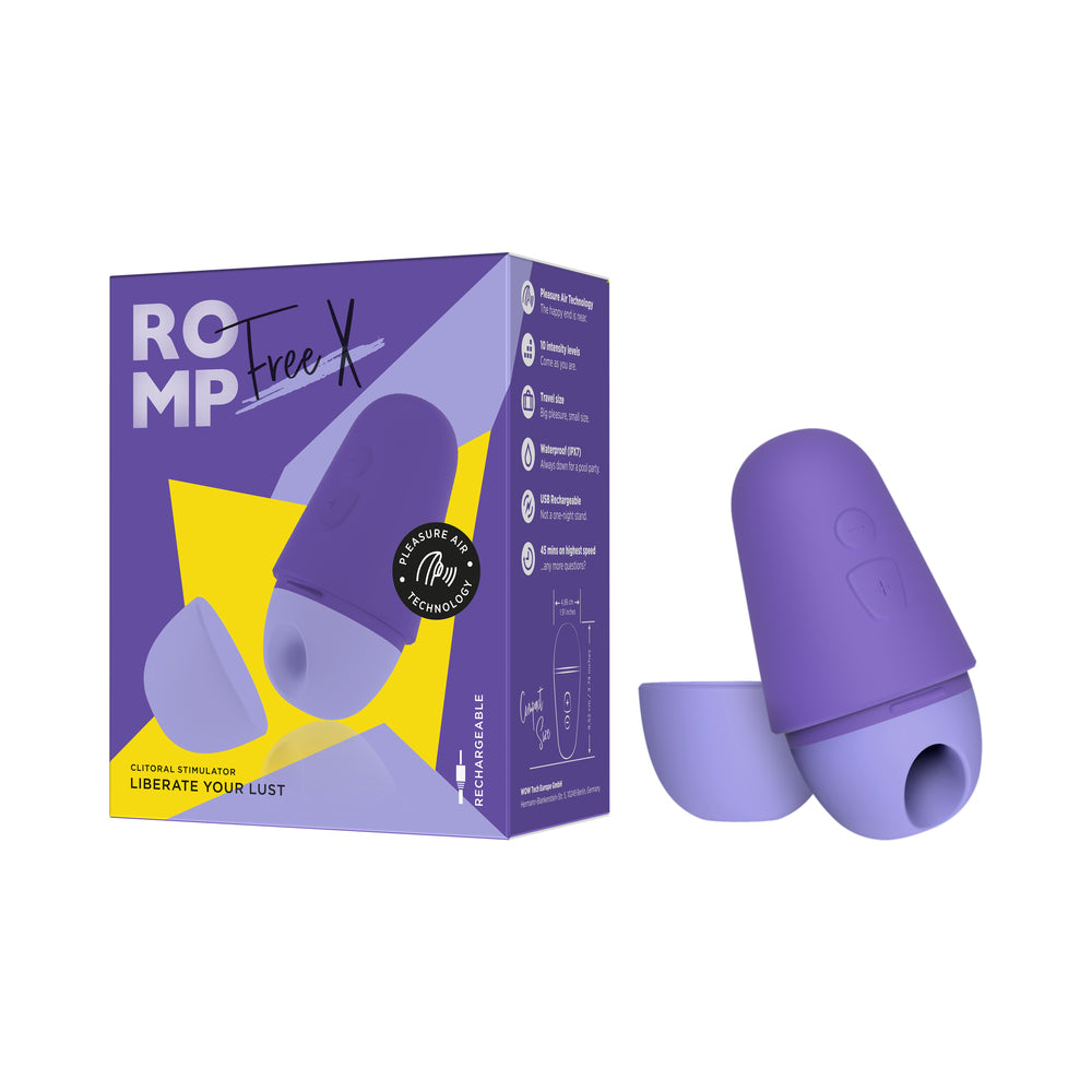 ROMP Free X clitoral stimulator in sleek black silicone with rose gold accents on a bedside table with travel case.
