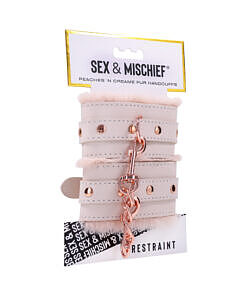 Pair of light peach faux fur handcuffs with adjustable black straps and quick-release buckles