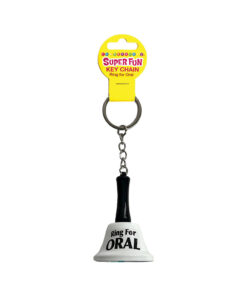 Super Fun Key Chain Ring For Oral pink silicone ring with tongue design resting on a wooden table beside car keys.