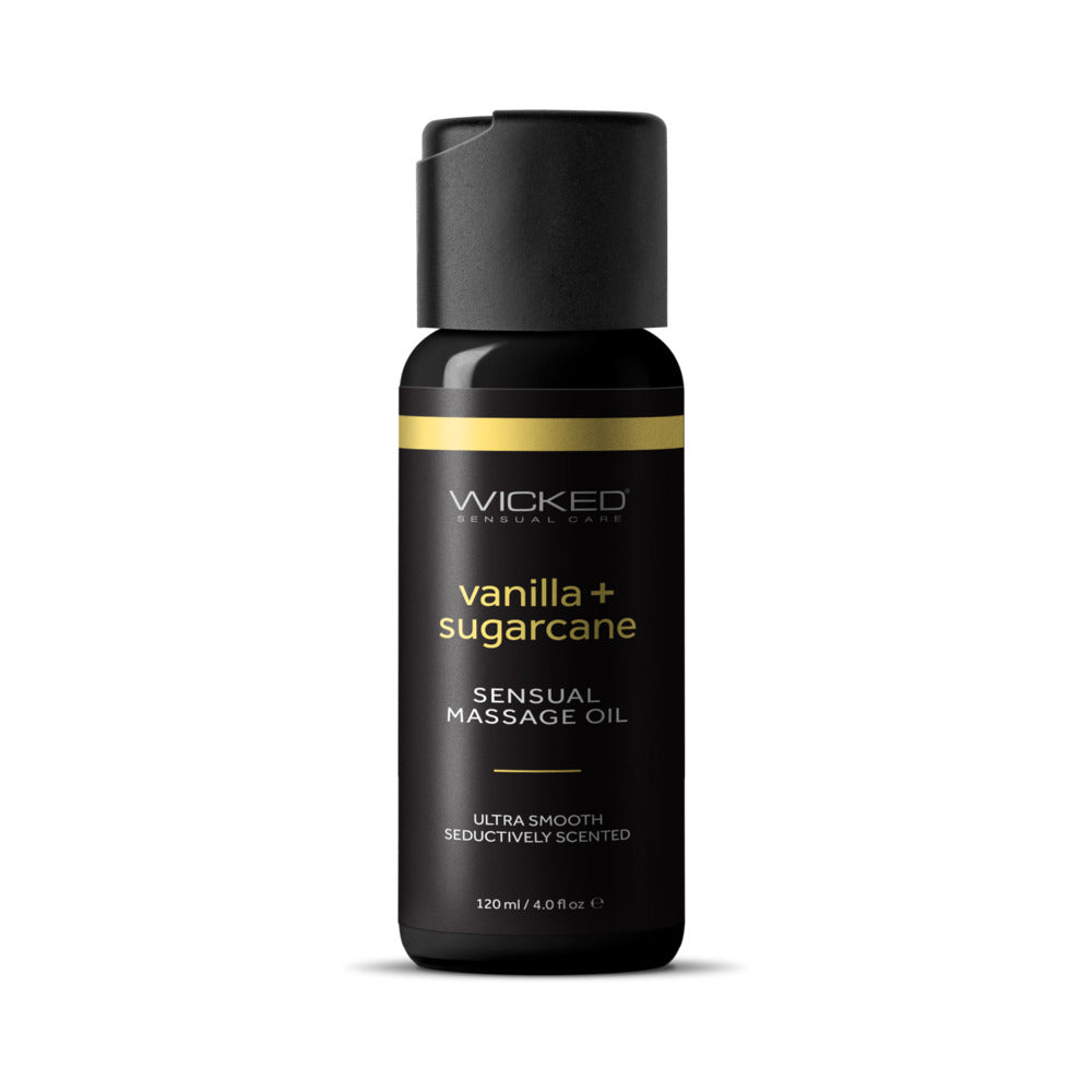 Wicked Vanilla and Sugarcane Massage Oil 4 oz bottle on spa setting with vanilla beans and sugarcane.