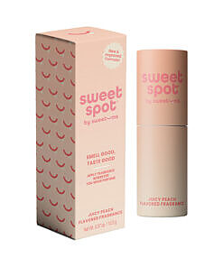 Sweetums Juicy Peach Flavored Fragrance stick on a peach-toned background