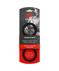 Medium black SEI MIO Handi-Cuffs silicone restraint cuffs resting on a satin sheet
