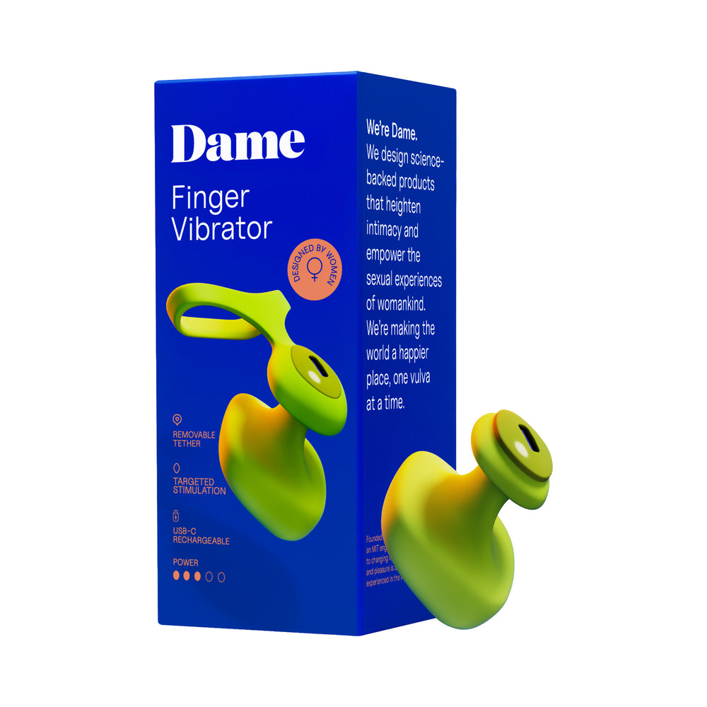 Dame Fin 2.0 Finger Vibrator in citrus yellow silicone held between two fingers against a soft grey background
