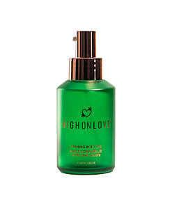 HighOnLove Firming Body Oil bottle with golden oil and natural botanical elements on a soft beige background.