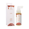 Doc Johnson Ease Throat Relaxing Spray Salted Caramel 2 oz bottle on a bedside table