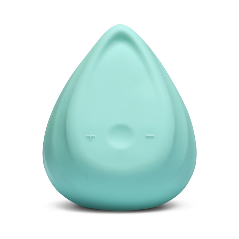 Biird Evii Vibrator Mint Green lying on a silky white surface with its curved
